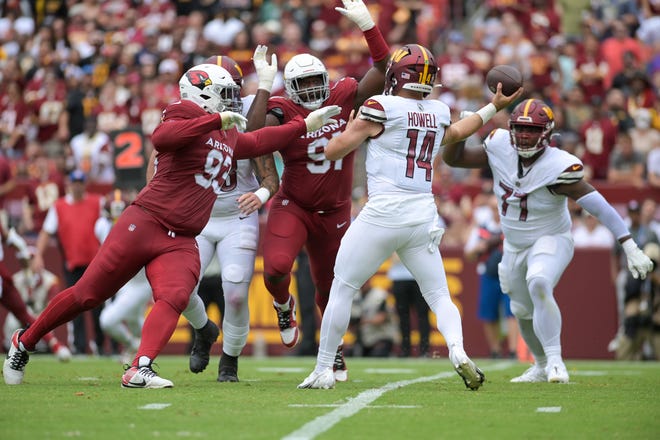 Sep 10, 2023; Landover, Maryland, USA; Washington Commanders quarterback Sam Howell (14) throw as defensive end Jonathan Ledbetter (93) and Arizona Cardinals defensive end L.J. Collier (91) applied pressure during the first half at FedExField. Mandatory Credit: Tommy Gilligan-USA TODAY Sports