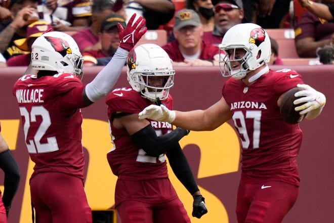 Sep 10, 2023; Landover, Maryland, USA; Arizona Cardinals safety K'Von Wallace (22) cornerback Marco Wilson (20) and linebacker Cameron Thomas (97) celebrate after scoring a touchdown against the Washington Commanders in the second half at FedExField. Mandatory Credit: Brent Skeen-USA TODAY Sports