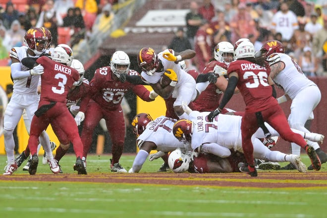 Sep 10, 2023; Landover, Maryland, USA; Washington Commanders running back Brian Robinson Jr. (8) dives over the pile for a second half first down against the Arizona Cardinals at FedExField. Mandatory Credit: Tommy Gilligan-USA TODAY Sports